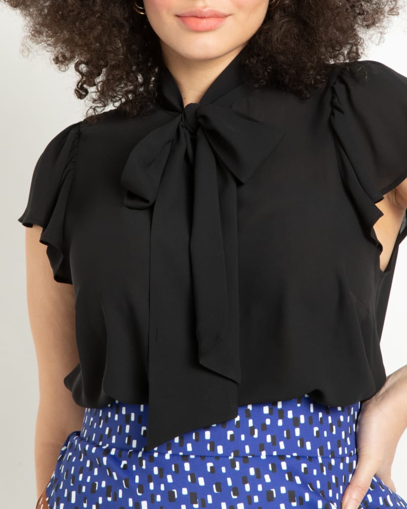 Front of a model wearing a size 14 Willow Flutter Sleeve Blouse in Black by ELOQUII. | dia_product_style_image_id:206794